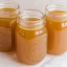 three jars of bone broth on white background