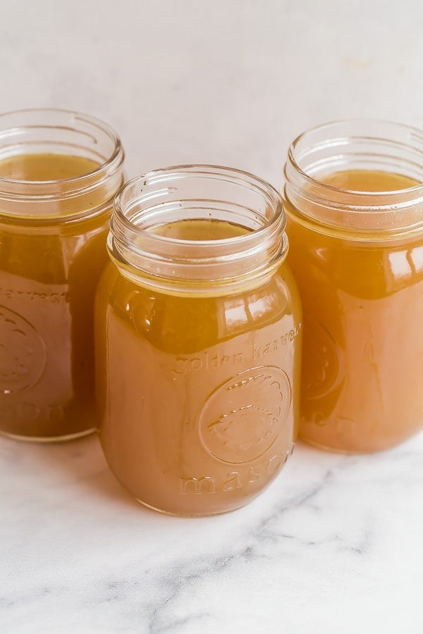 three jars of bone broth on white background