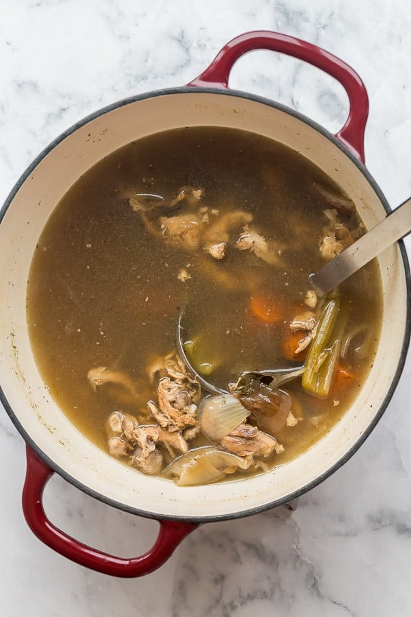 overhead image of dutch oven with chicken carcass and vegetables