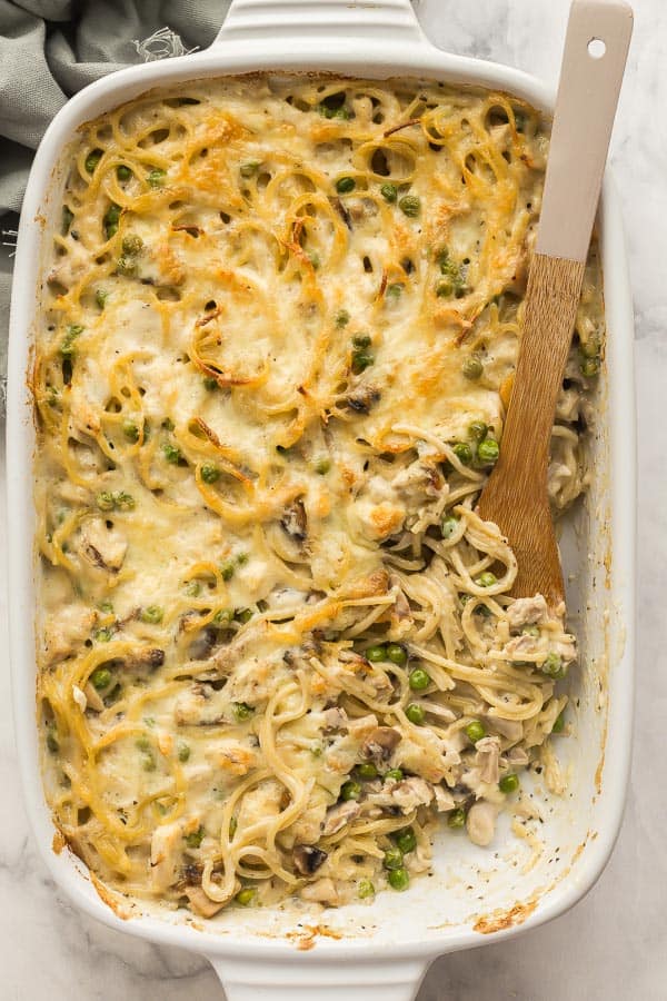 overhead image of wooden spoon stuck in tetrazzini pan