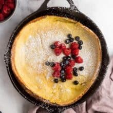 overhead image of dutch baby with powdered sugar and berries