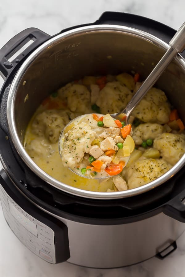 chicken and dumplings being scooped out of instant pot