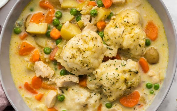 overhead image of chicken and dumplings in grey bowl