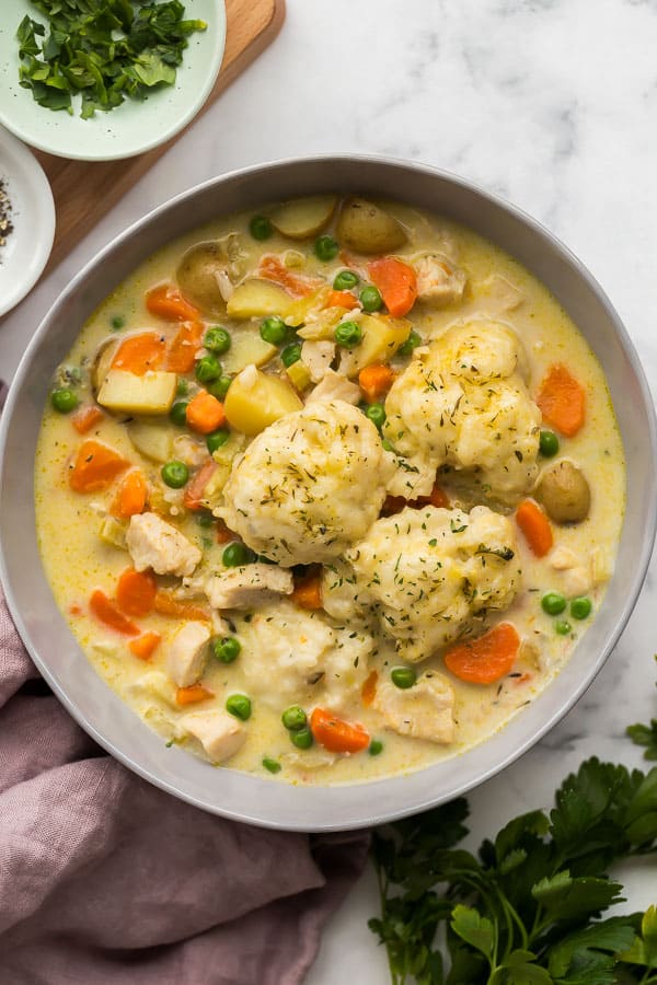 overhead image of chicken and dumplings in grey bowl