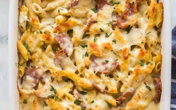 overhead image of kielbasa pasta bake in white baking dish