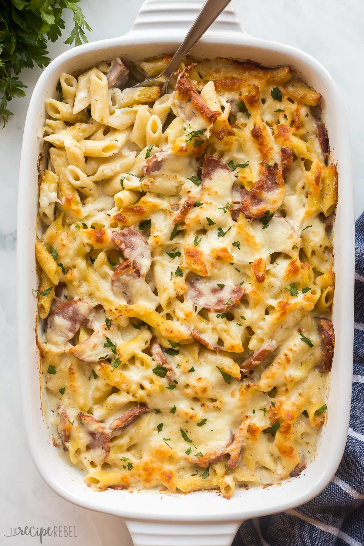 overhead image of kielbasa pasta bake in white baking dish