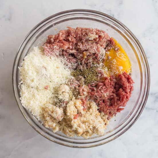 overhead image of meatball ingredients in glass bowl