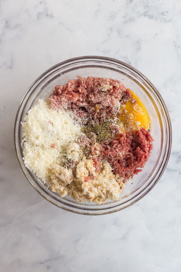 overhead image of meatball ingredients in glass bowl