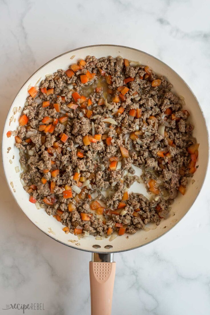 ground beef and vegetables cooked in white skillet