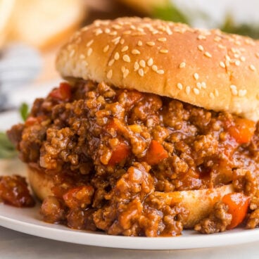 close up image of sloppy joes on sesame seed bun