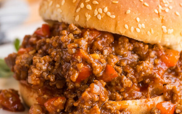 close up image of sloppy joes on sesame seed bun