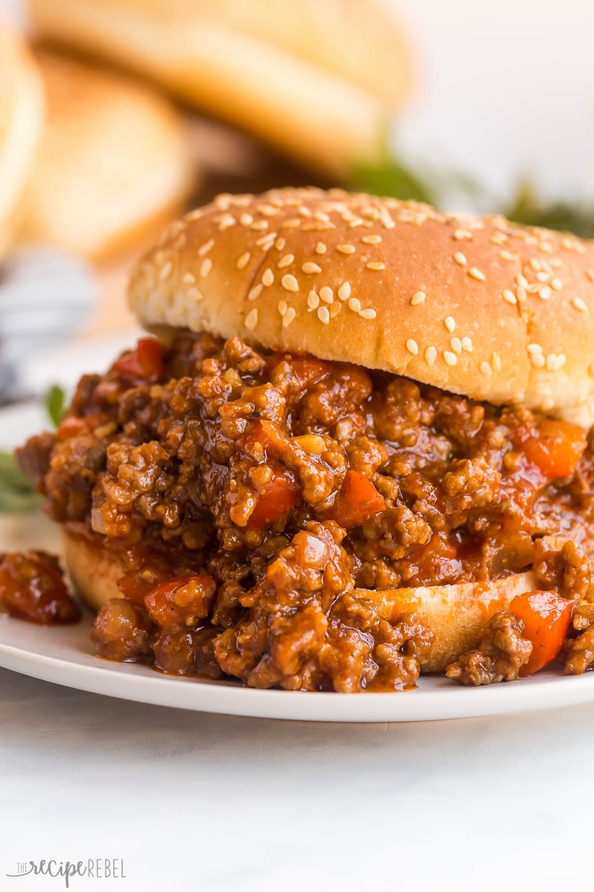 close up image of sloppy joes on sesame seed bun