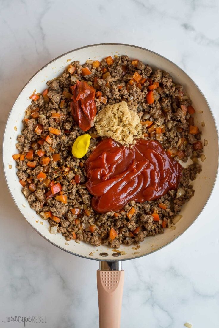 sauce ingredients added to cooked ground beef in skillet