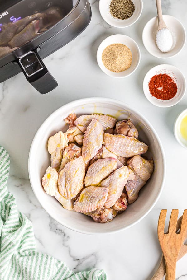 split chicken wings in bowl ready for seasoning