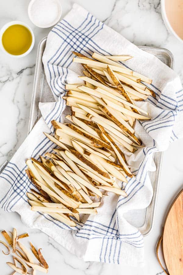 cut potatoes drying on towel