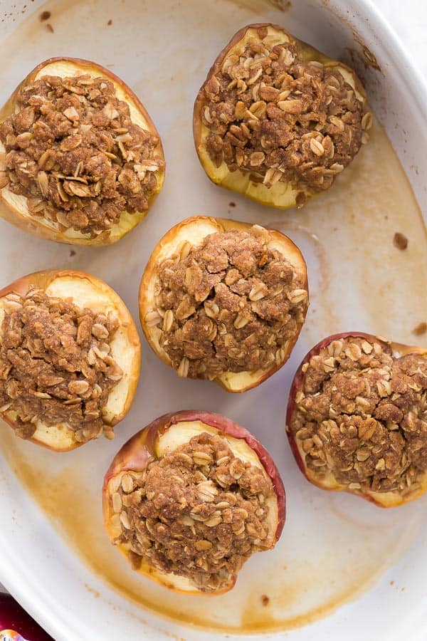 overhead image of halved baked apples with streusel