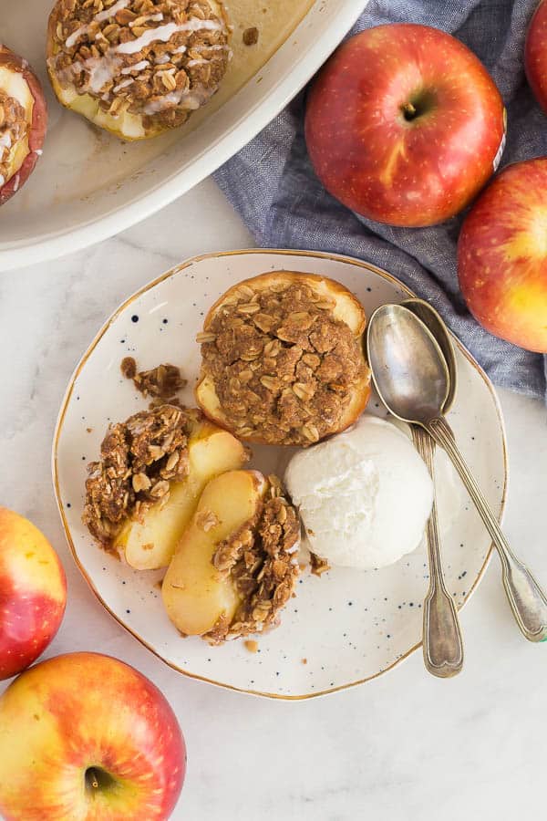 overhead image of sliced baked apple on plate with ice cream