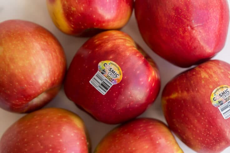 close up images of Cosmic Crisp apples with sticker