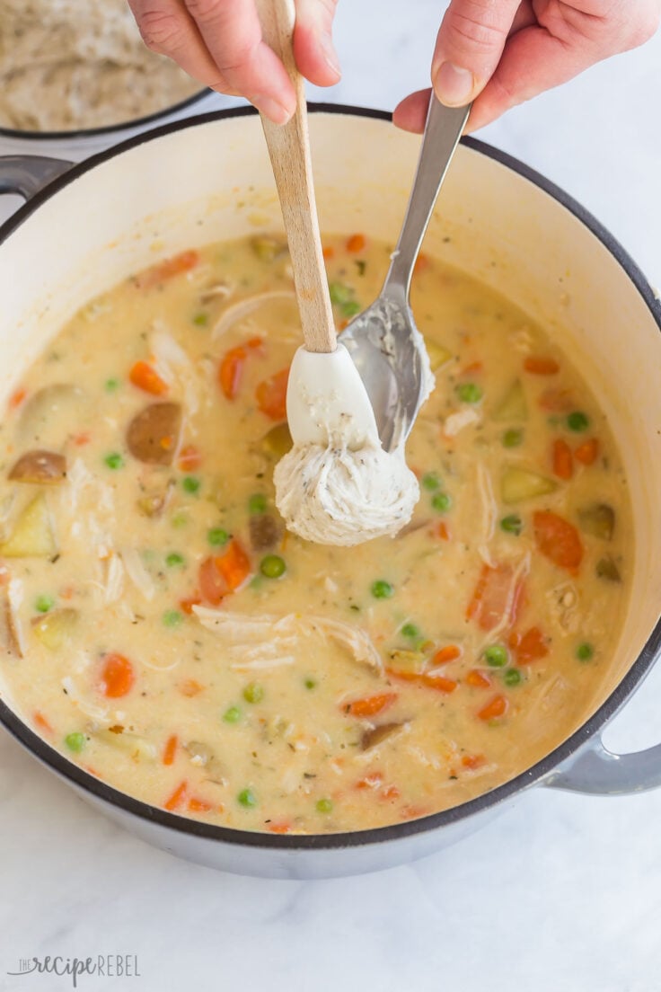 using a spoon and a spatula to make dumplings on top of stew