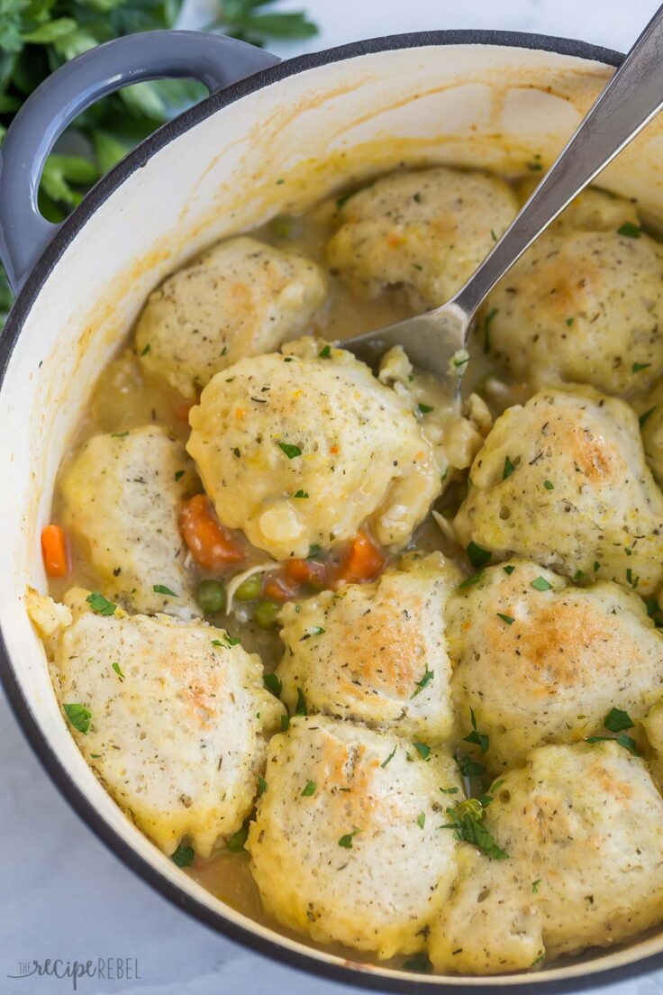 These Bisquick Dumplings are so easy to make and you can simmer them on homemade chicken stew or any soup recipe! Made with Bisquick, milk and Italian seasoning, they are simple and flavorful. #bisquick #recipes #dinner | easy dinner ideas | bisquick recipes | soup dumplings | chicken and dumplings | dinner ideas | easy recipes metal spoon scooping dumpling out of stew