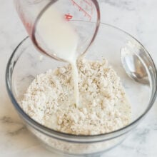 milk being poured into bisquick to make dumplings
