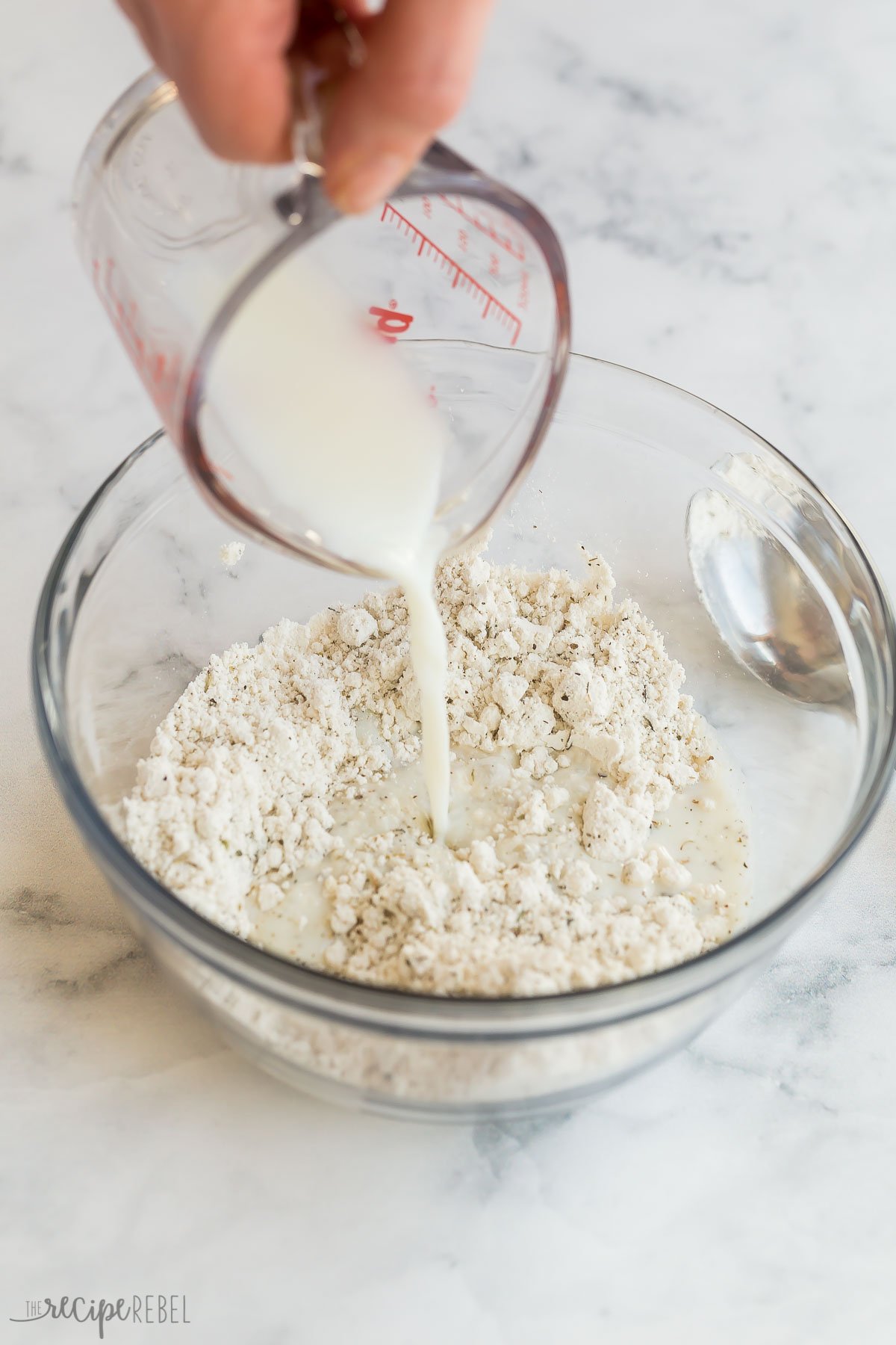 milk being poured into bisquick to make dumplings