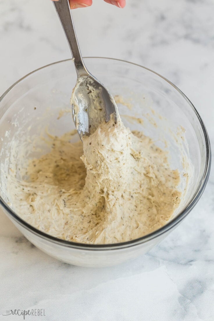 spoon showing sticky thick consistency of bisquick dumpling mixture