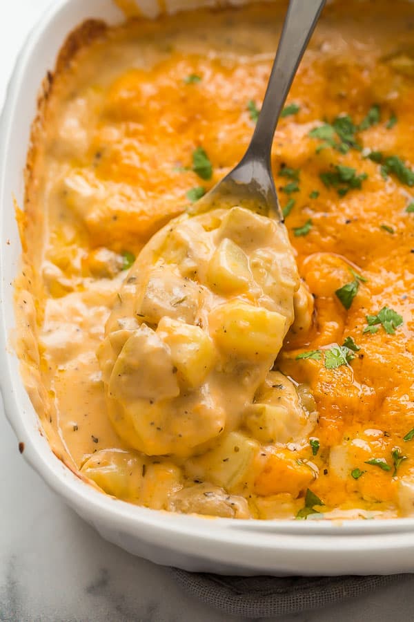 close up image of cheesy potatoes on spoon