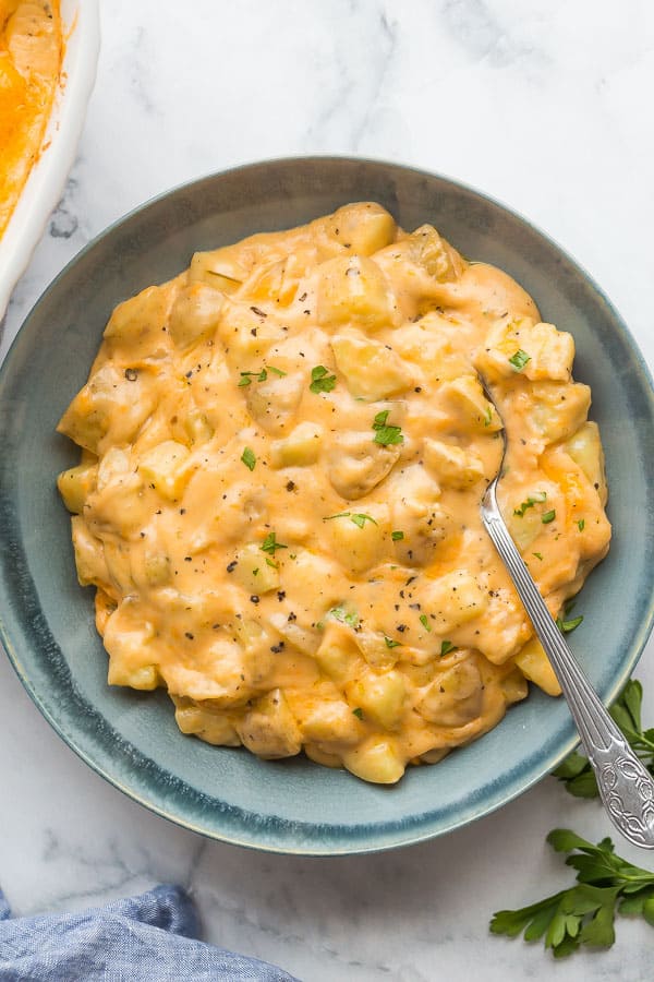 overhead image of cheesy potatoes in blue bowl