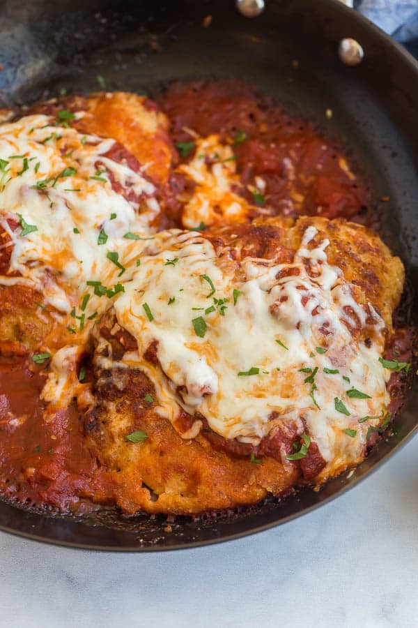 close up image of chicken parmesan in pan