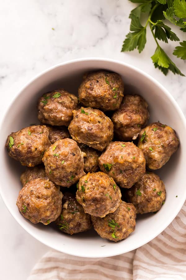 overhead image of baked meatballs in white bowl