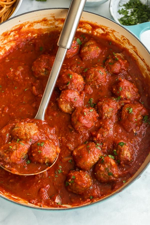 close up image of meatballs in tomato sauce in pan