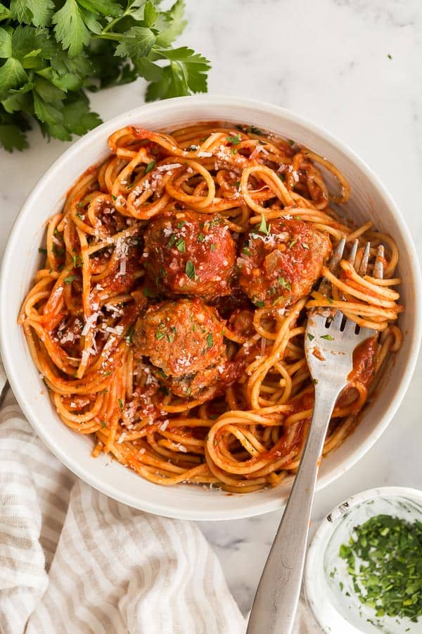 overhead image of spaghetti and meatballs in white bowl