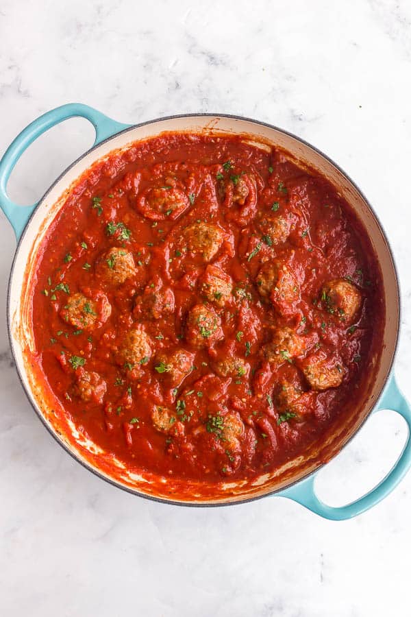 overhead image of meatballs in tomato sauce in blue pan
