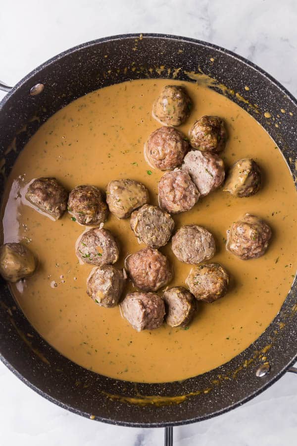 swedish meatball sauce in pan with meatballs added