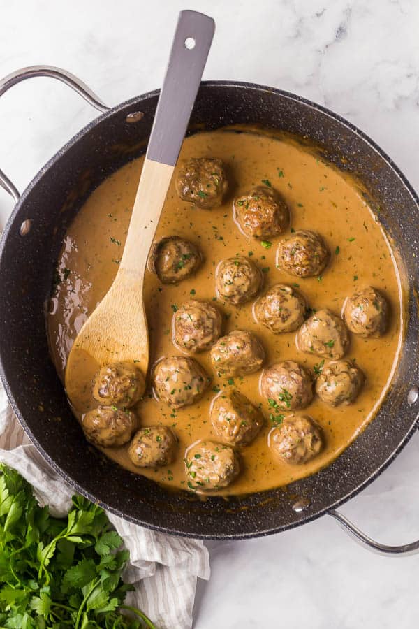 overhead image of swedish meatballs in gravy in black pan