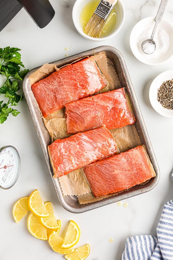 overhead image of uncooked salmon fillets on sheet pan