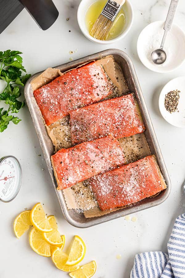 salmon fillets with seasoning on sheet pan