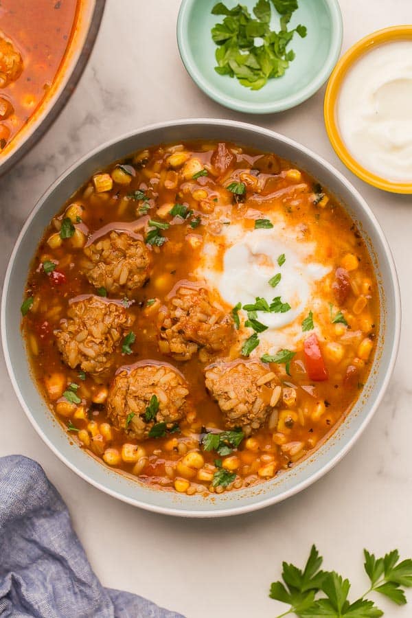 overhead image of albondigas soup with sour cream