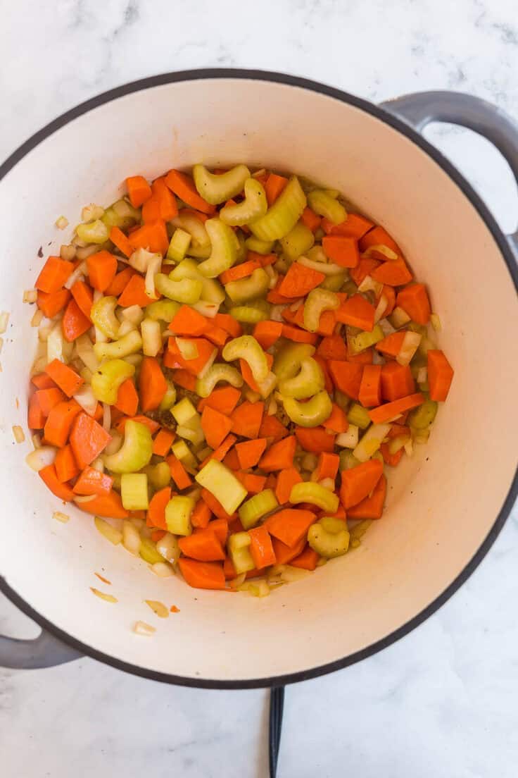carrots celery and onion in a soup pot.