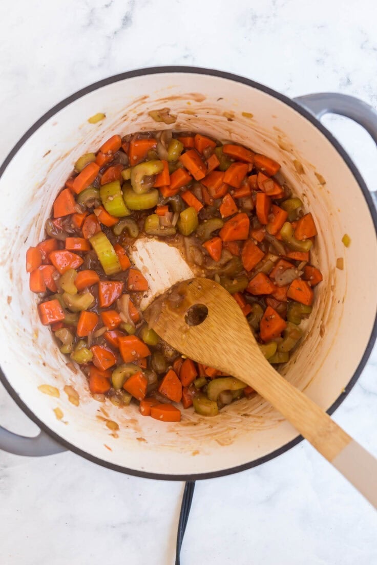 beef broth in a pot deglazing vegetables.