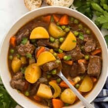 overhead image of beef stew in bowl with spoon