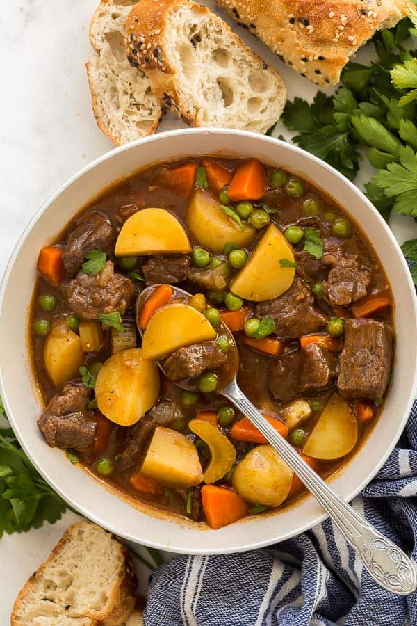 overhead image of beef stew in bowl with spoon