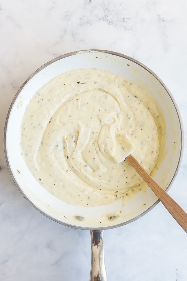 finished alfredo sauce in white saucepan