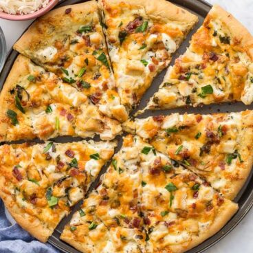 close up overhead image of sliced white pizza