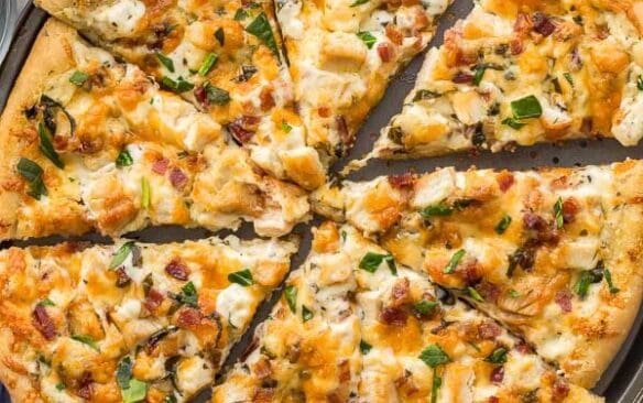 close up overhead image of sliced white pizza