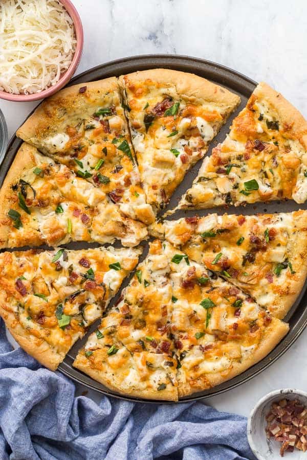 close up overhead image of sliced white pizza