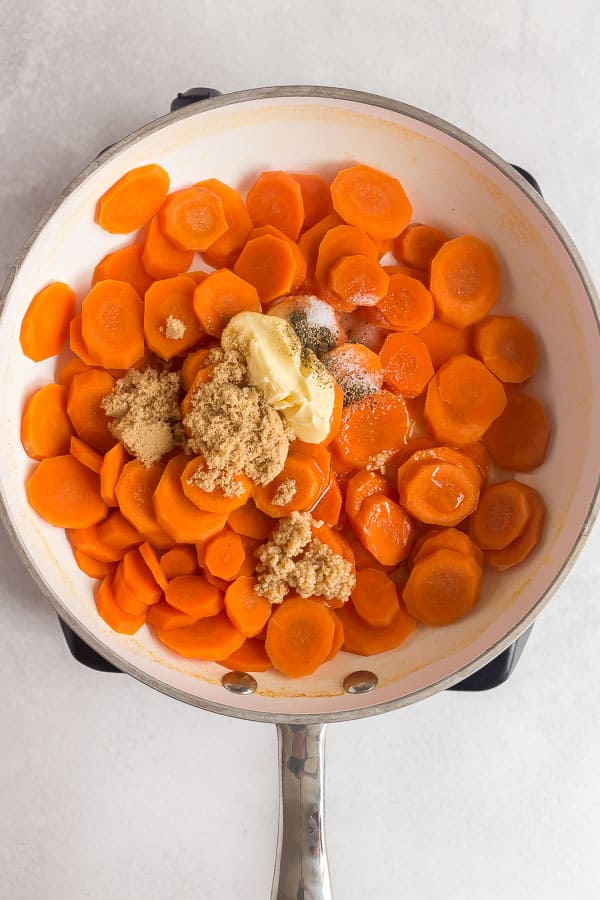 carrots in white pan with butter brown sugar and honey