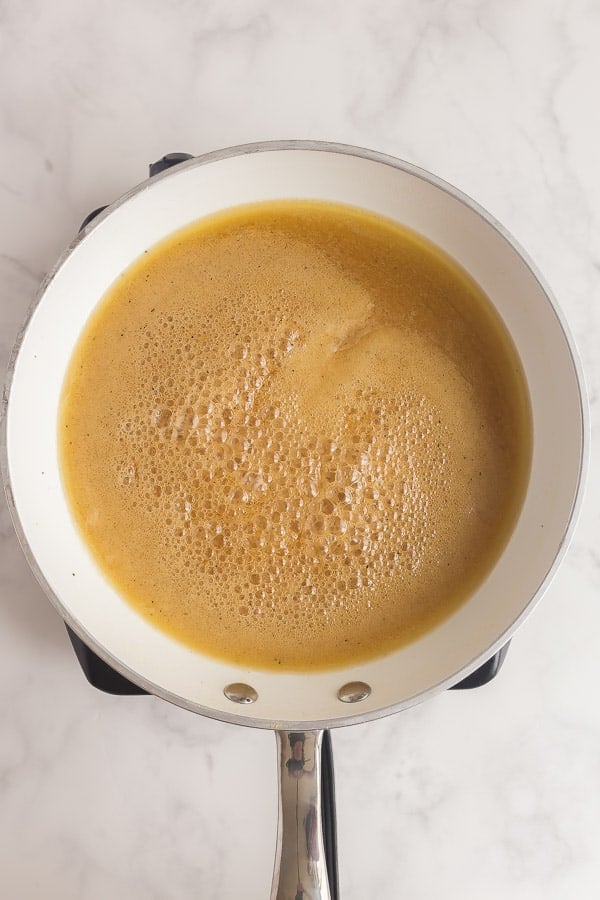 honey glaze boiling in white skillet