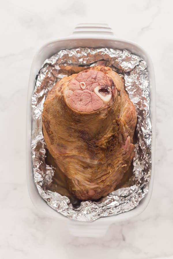 cooked ham in baking dish ready for glaze